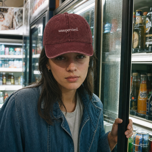 Unsupervised. embroidered vintage cap in maroon, worn in a late-night corner shop