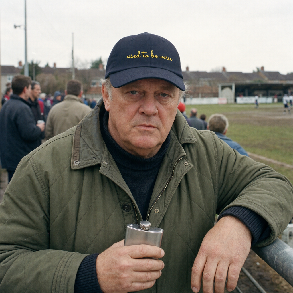 Navy classic cap embroidered “used to be worse” in gold, worn at a Sunday league football match
